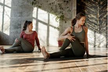 two women doing yoga