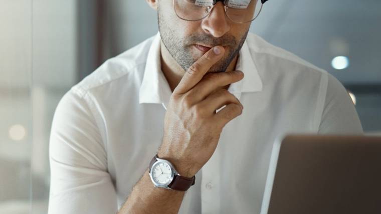 Business man looking at his laptop