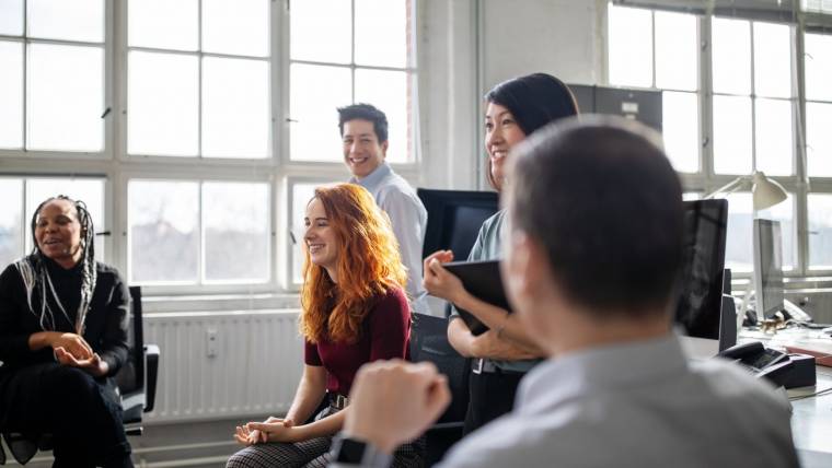 people smiling at a business meeting