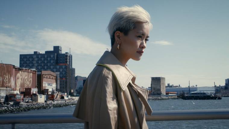 Woman in an industrial area gazing pensively to the side