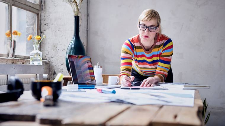 A freelancer works at a table