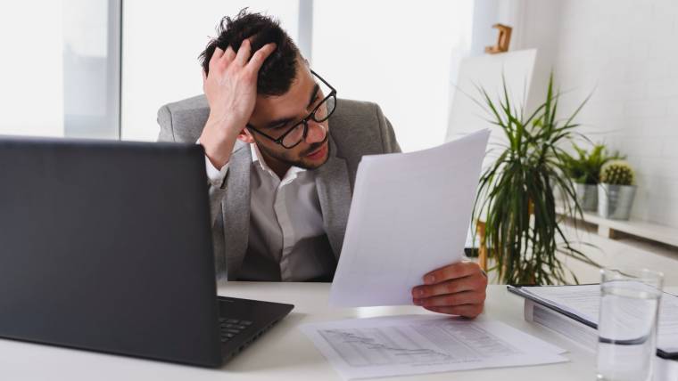 man at desk looking stressed