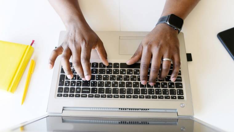 hands typing on a laptop