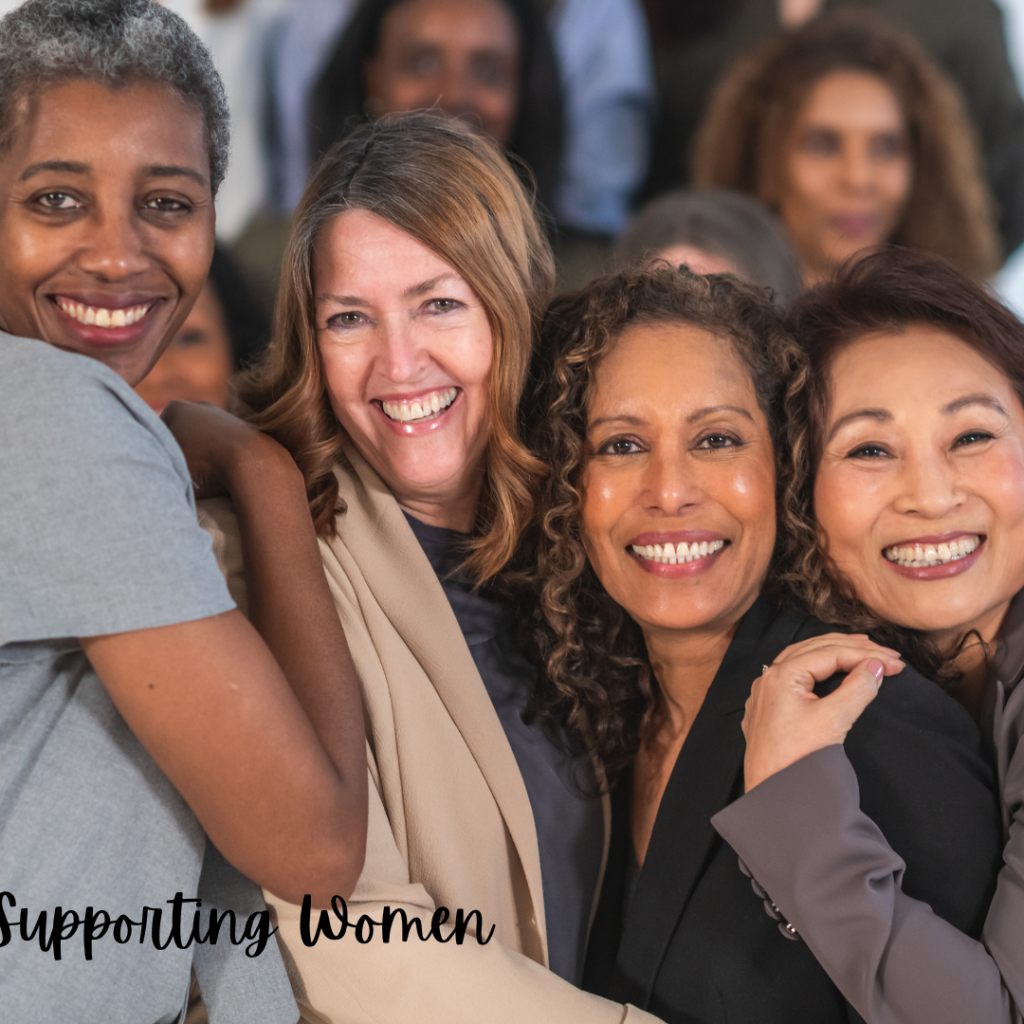 four women smiling and embracing each other