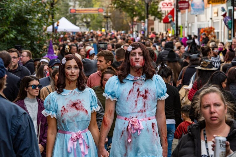 Revellers walk the streets on Halloween in Salem, Massachusetts on October 31, 2021. - The city is t...